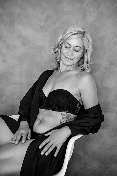 A glamourous woman reclines on her chair