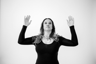 Striking woman poses for the camera with her arms outstretched
