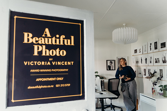 A door opens showing the interior of a photography studio in Nelson