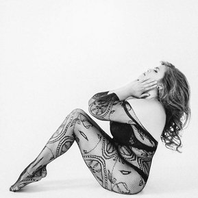 Stunning Asian woman wearing full body stocking doing striking pose. 