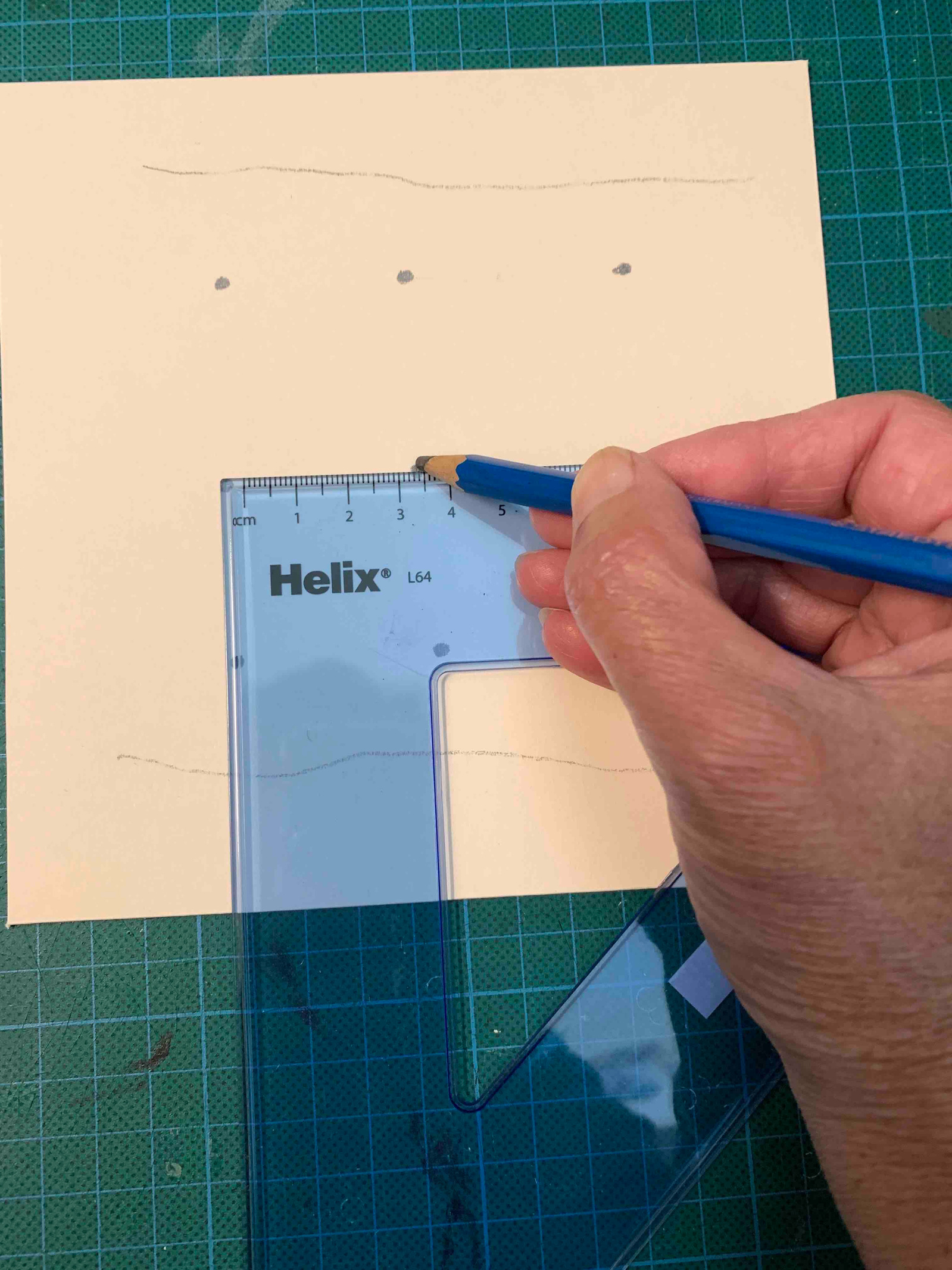 Use a set square to mark out the area where the holes will be punched