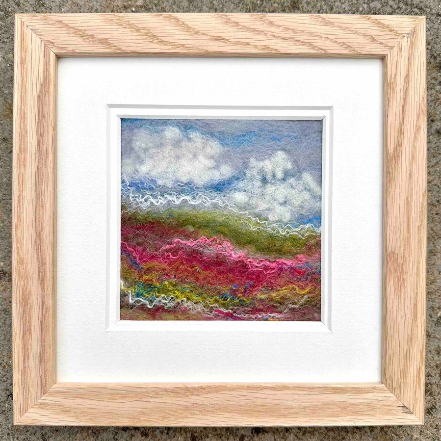 Wet felted pink and green cheerful landscape. The silk gives a lovely highlight to the work. Inspired by the English countryside. By Upanddowndale textile artist Lynn Comley