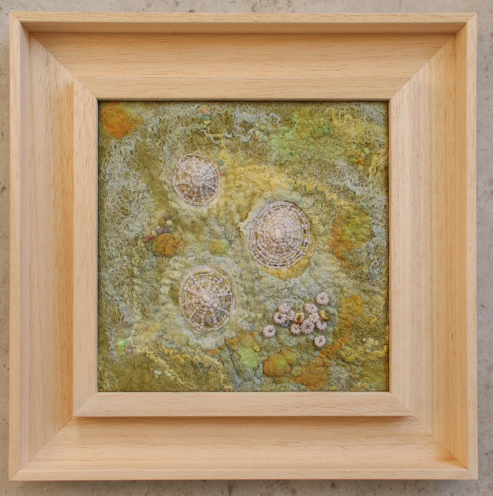 Textured felt artwork depicting limpet shells with hand embroidery by Lynn Comley a Yorkshire based textile artist