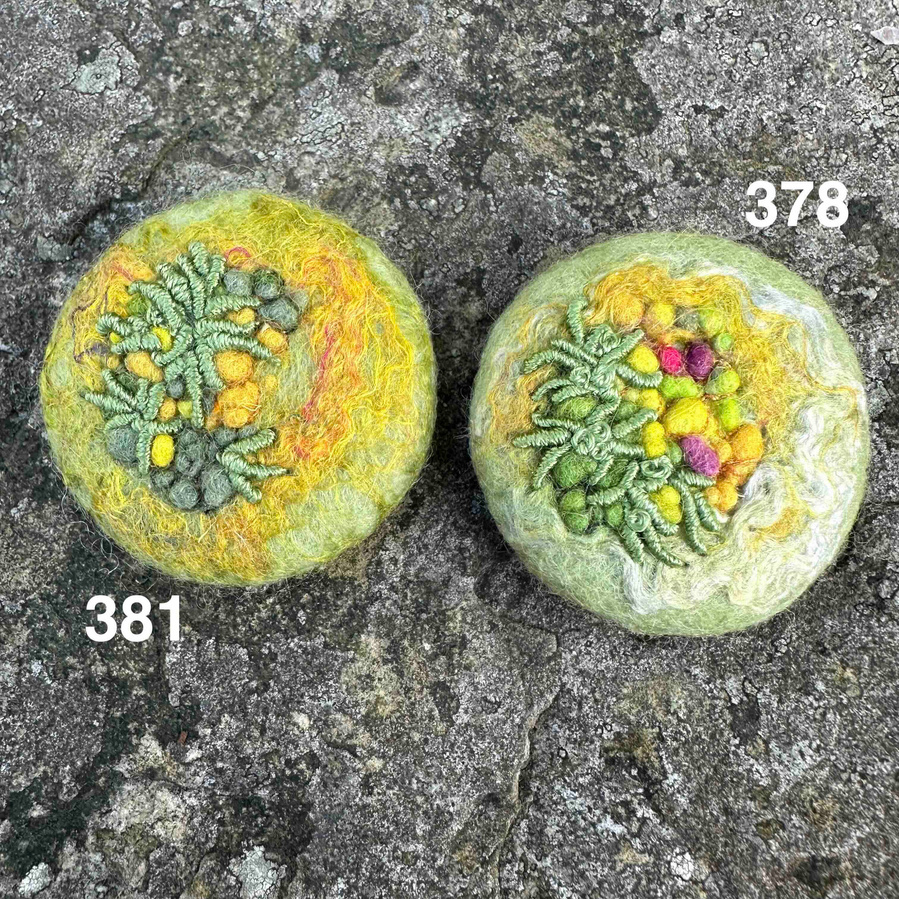 Moss inspired embroidered brooches by Lynn Comley textile artist. Connecting with the forest floor. Handcrafted from wool. UpandDownDale textile artist in the UK