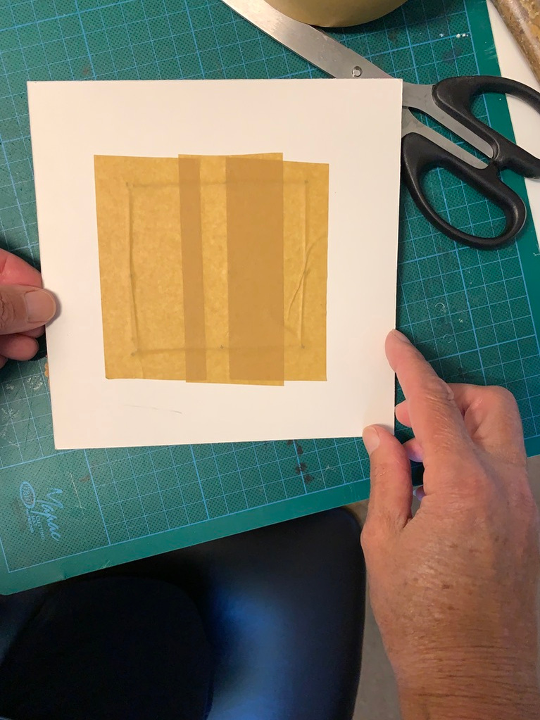 Secure the back of the mount board with artist tape. Lynn Comley strings her work onto conservation board in preparation to framing her wet felted artwork
