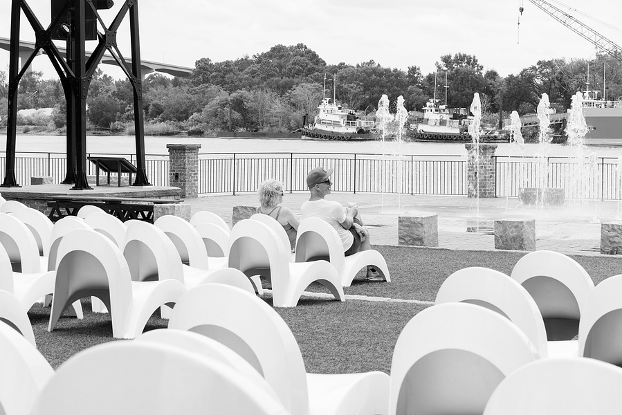 Couple relaxes on a fresh afternoon outside the JW Marriot Hotel, Savannah, GA,  October 2024
