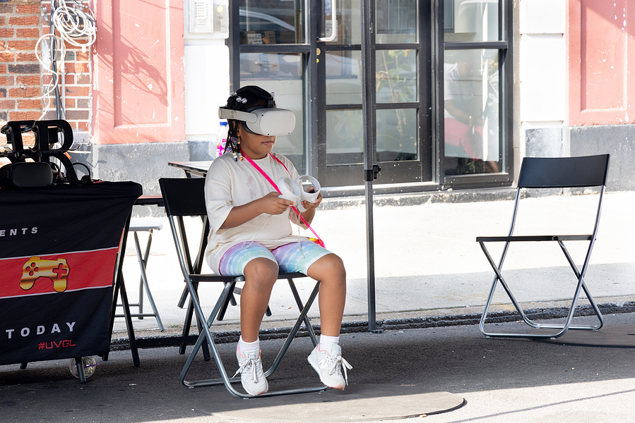 Kid navigating a virtual reality during a block party in Brooklyn, NY, September 2024
