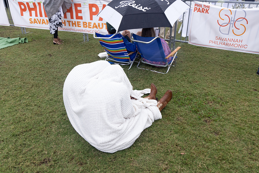 Couples shield themselves from the rain during the Savannah Philharmonic Festival, Savannah, GA, October 2024
