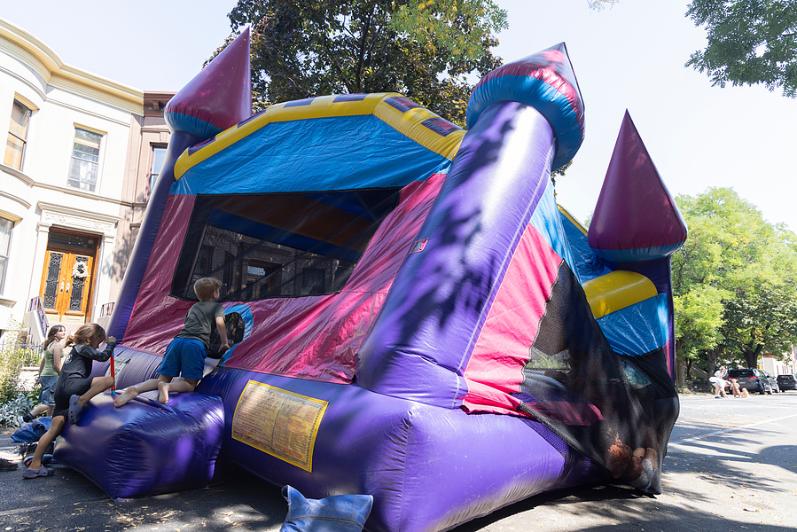 A bouncy house on the verge of collapse is invaded by kids playing during a block party in Brooklyn, NY, September 2024
