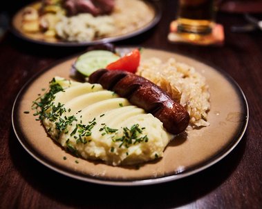 Bratwurst and sauerkraut with mashed potatoes on a table in a pub in Berlin
