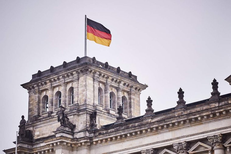 The grand Reichstag building was home to Germany's lower parliament. A German flag can be seen on top, flying in the wind.