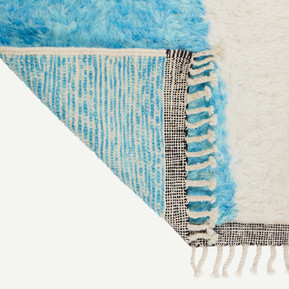 Bright blue, white and black Moroccan Berber rug. A shot of the bottom corner turned over for a back shot of the textures