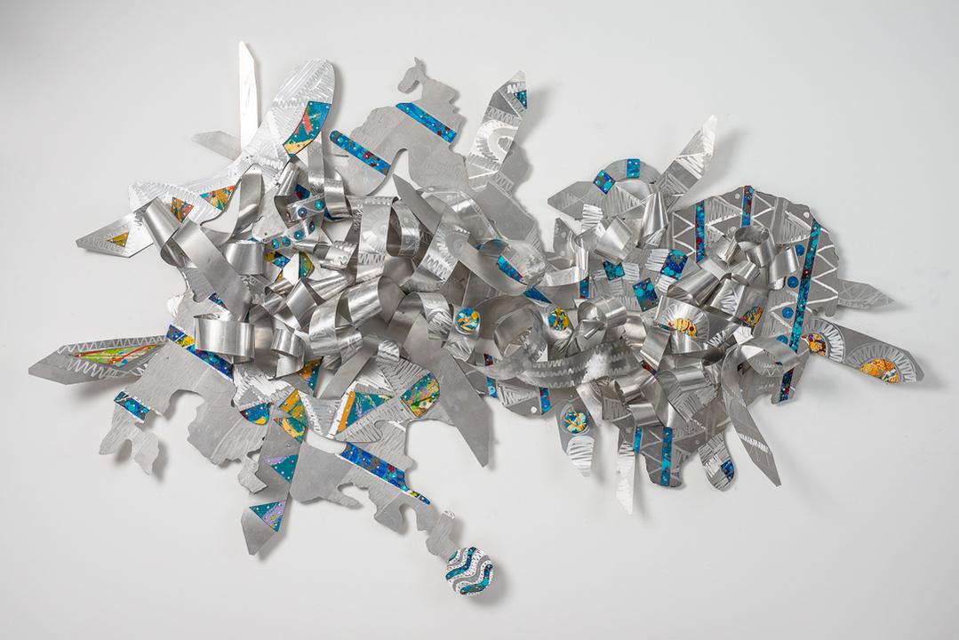 Dancing with Heavenly Blessings-Abstract Art Piece Hung on A Wall With Various Shapes that Resembles Ties. The Ties are Bent in Various Ways. The Piece is Silver with Orange and Blue Detail.