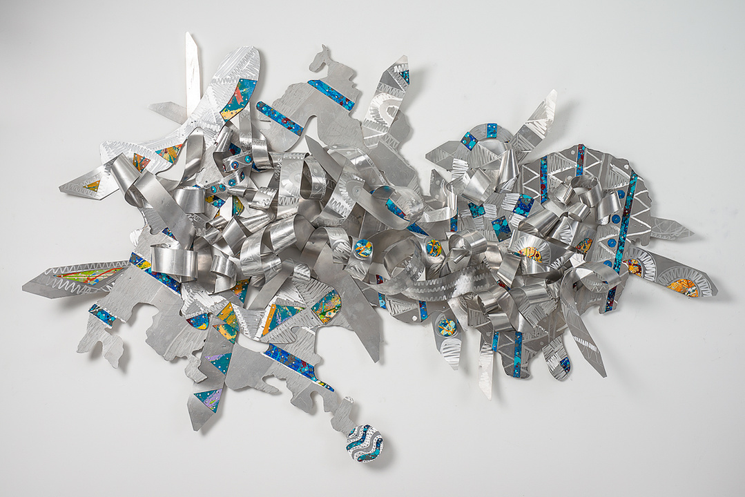 Dancing with Heavenly Blessings-Abstract Art Piece Hung on A Wall With Various Shapes that Resembles Ties. The Ties are Bent in Various Ways. The Piece is Silver with Orange and Blue Detail.