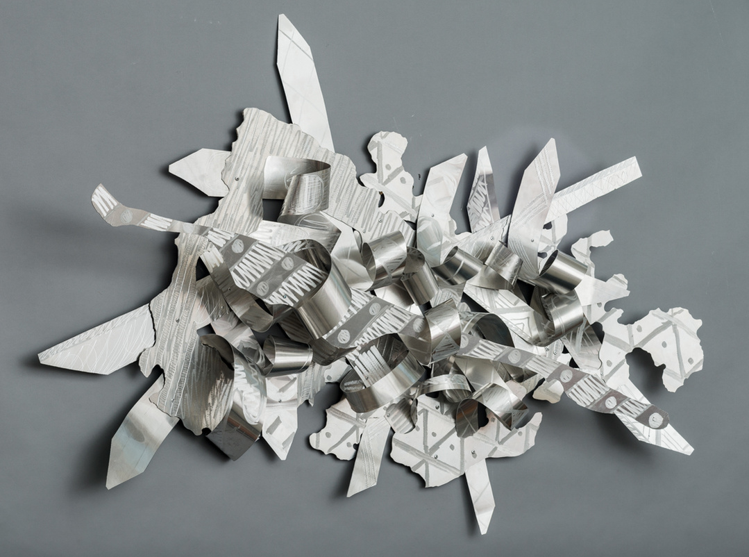 When Joy Chases Faith-Abstract Art Piece  With Various Shapes that Resembles Ties. The Ties are Bent in Various Ways. The Piece is Silver. 