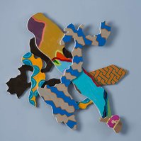 Below The Mason Dixon Line I-Multicolored Abstract Art Piece Hung on A Wall With Various Shapes that Resembles Ties. The Ties are Bent in Various Ways. 