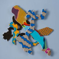 Below The Mason Dixon Line I-Multicolored Abstract Art Piece Hung on A Wall With Various Shapes that Resembles Ties. The Ties are Bent in Various Ways. 