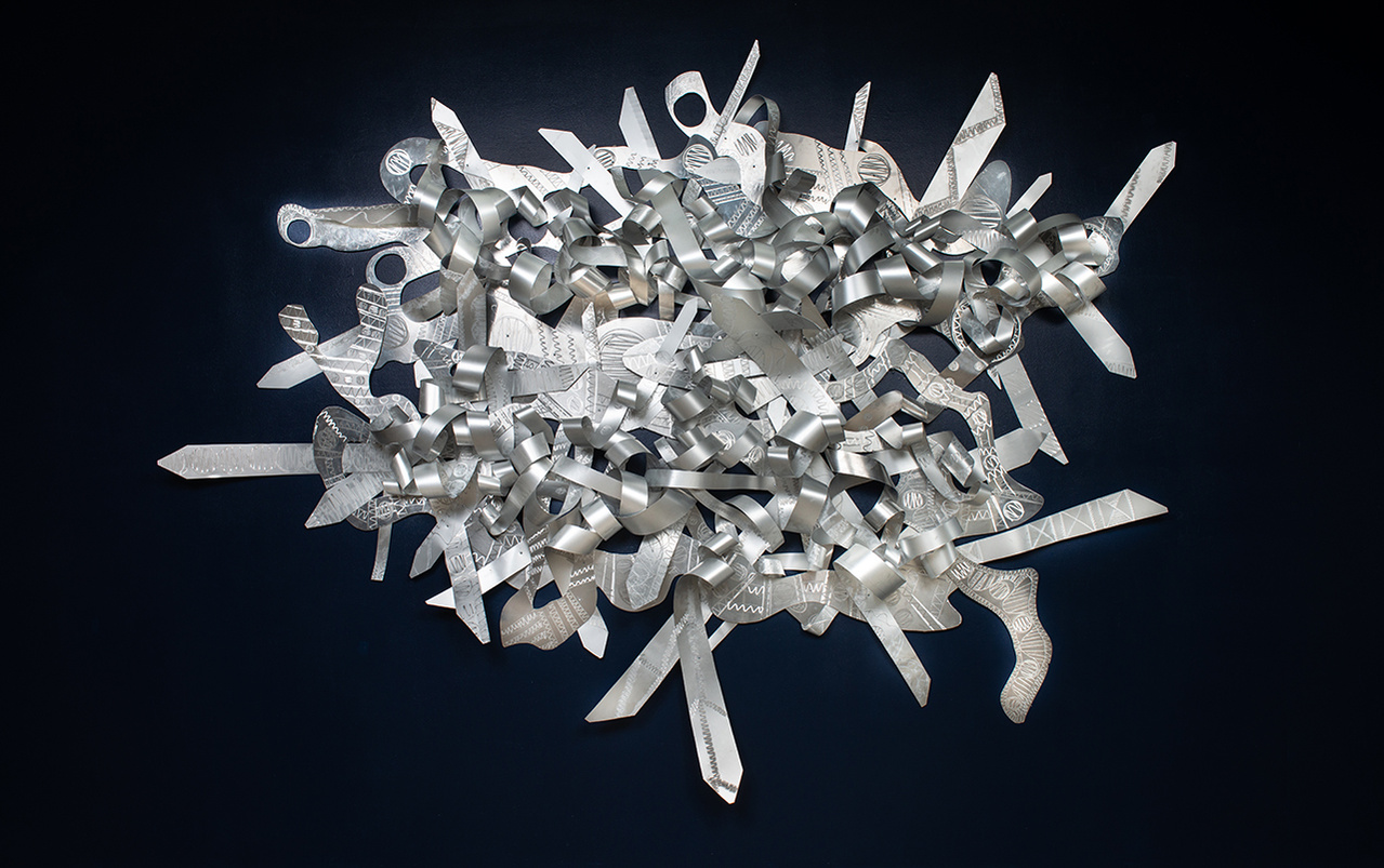 When My Scars-Abstract Art Piece With Various Shapes that Resembles Ties. The Ties are Bent in Various Ways. The Piece is Silver.