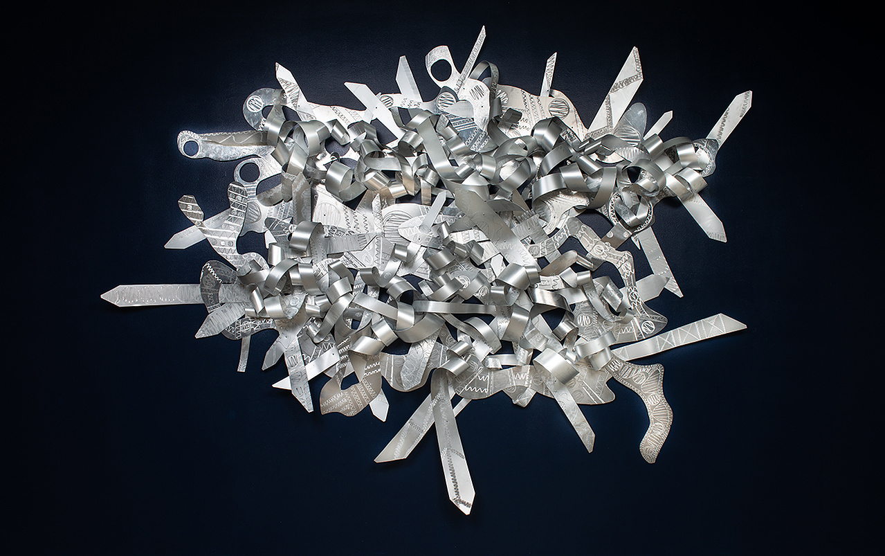 When My Scars-Abstract Art Piece With Various Shapes that Resembles Ties. The Ties are Bent in Various Ways. The Piece is Silver.