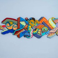 Unforseen Challenges-Multicolored Abstract Art Piece Hung on A Wall With Various Shapes that Resembles Ties. The Ties are Bent in Various Ways. 