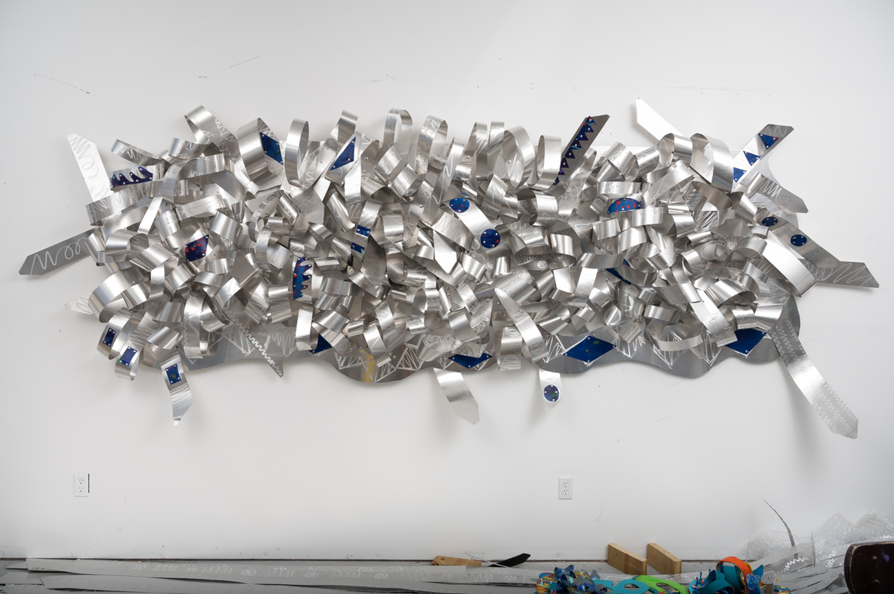 All Tied UP-Abstract Art Piece With Various Shapes that Resembles Ties. The Ties are Bent in Various Ways. The Piece is Silver.