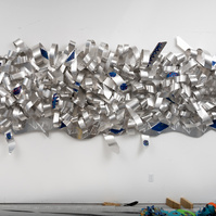 All Tied UP-Abstract Art Piece With Various Shapes that Resembles Ties. The Ties are Bent in Various Ways. The Piece is Silver.