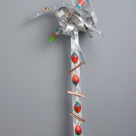 Another Strange Fruit-Abstract Art Piece With Various Shapes that Resembles Ties. The Ties are Bent in Various Ways. The Piece is Silver With Detail of Red Strawberries.