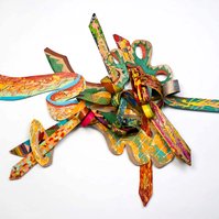 3 A. M. Wings For TC-Multicolored Abstract Art Piece Hung on A Wall With Various Shapes that Resembles Ties. The Ties are Bent in Various Ways. 