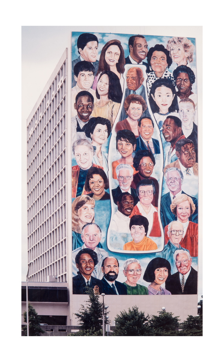 The Coca Cola Centennial Olympic Mural, 15 Story  Commission for the 1996 Olympics, Atlanta GA-This mural of people of different genders and races with a clear Coca Cola Bottle in the middle. This mural is on the side of a tall building.