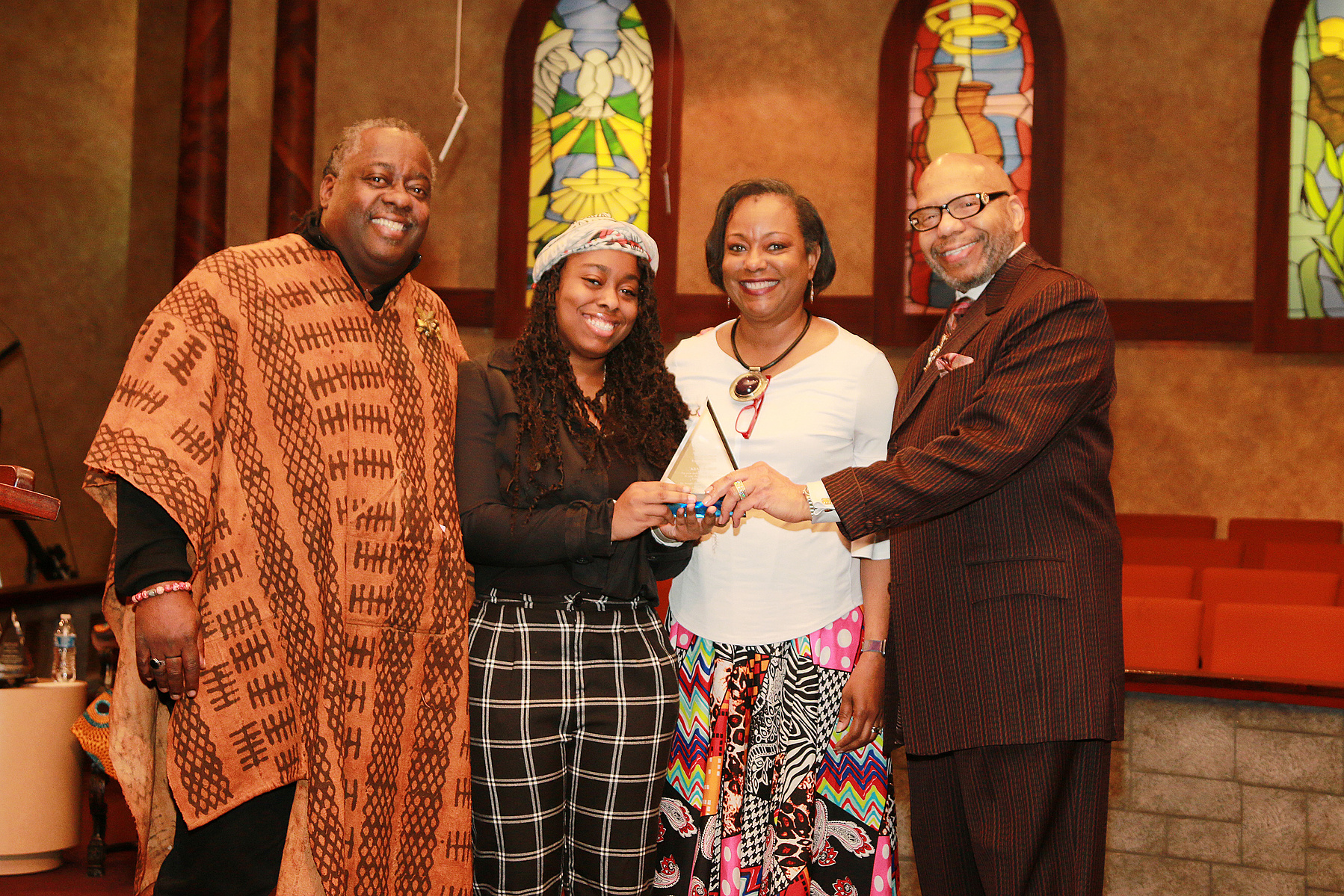 2020 TrailBlazer Award - Salem Bible Church- Four People In a Church Posing for a Photo. Two People are Holding the Same Award Trophy.