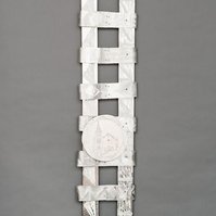 Swing Low  Sweet Chariot For The Emmanuel 9 -Abstract Art Piece With Various Shapes that Resembles Ties. The Ties are Bent in Various Ways. The Piece is Silver With Small Color Detail.