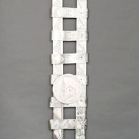 Swing Low  Sweet Chariot For The Emmanuel 9 -Abstract Art Piece With Various Shapes that Resembles Ties. The Ties are Bent in Various Ways. The Piece is Silver With Small Color Detail.