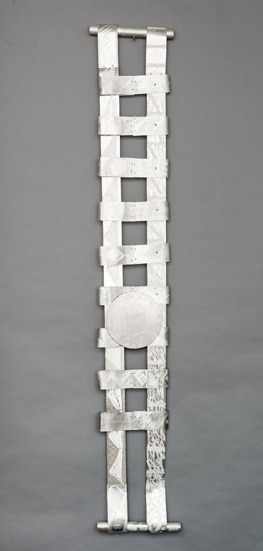Swing Low Sweet Chariot For The Emmanuel 9  Back-Abstract Art Piece With Various Shapes that Resembles Ties. The Ties are Bent in Various Ways. The Piece is Silver With Small Color Detail.