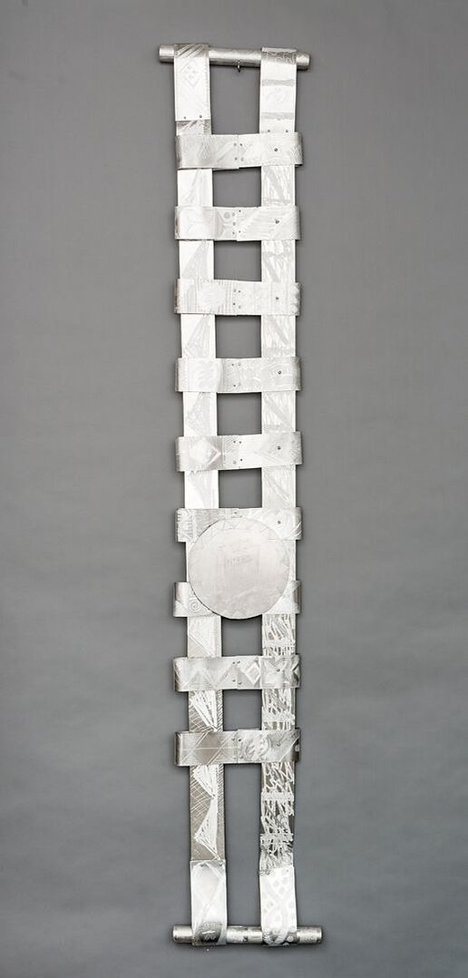 Swing Low Sweet Chariot For The Emmanuel 9  Back-Abstract Art Piece With Various Shapes that Resembles Ties. The Ties are Bent in Various Ways. The Piece is Silver With Small Color Detail.