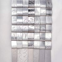 Another Handwriting- Silver Art Piece That Resembles A Blanket 