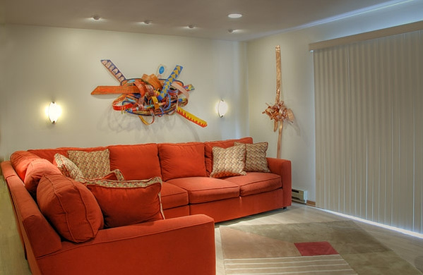 Passion With A Purpose - In The Collection Of Maria Campbell, Racine, WS-Abstract Art Piece Mixed Media on Wood With Various Shapes And Warm Colors.This Piece is on a Wall Next to A Orange Couch.
