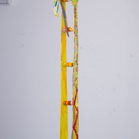 Ladder For Ms. Catlett-Abstract Yellow Ladder With Abstract Ties On The Top. The Ties Are Multicolored.