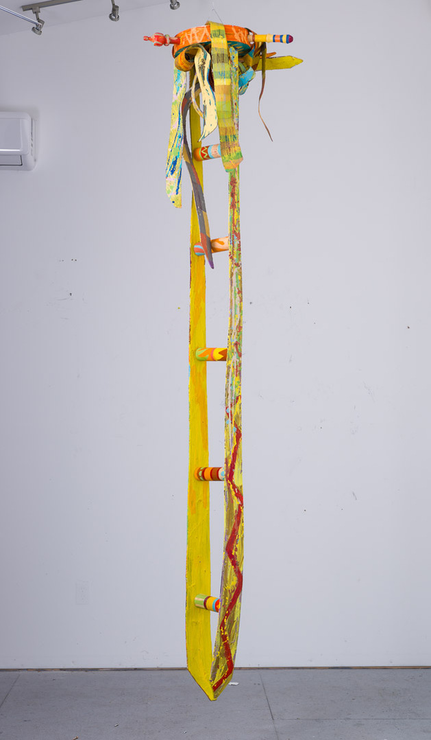 Ladder For Ms. Catlett-Abstract Yellow Ladder With Abstract Ties On The Top. The Ties Are Multicolored.