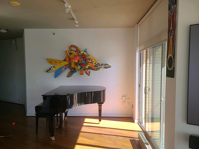 Living Through Adversity 43x86x8 Mixed Media on wood Private Commission Dareen Chaplin, Washington DC-Abstract Art Piece Mixed Media on Wood With Various Shapes And Warm Colors.This Piece is on a Wall Next to A Piano.