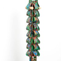 Triumph Over Fears- Totem Made of Ties with a Bright Green Base Color and Multicolor Splatter on a Wooden Base.