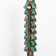 Triumph Over Fears- Totem Made of Ties with a Bright Green Base Color and Multicolor Splatter on a Wooden Base.