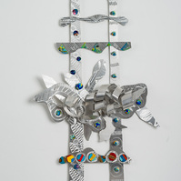 Seekin A Higher Ground III-Abstract Art Piece With Various Shapes that Resembles Ties. The Ties are Bent in Various Ways. The Piece is Silver With Small Color Detail. 