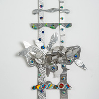 Seekin A Higher Ground III-Abstract Art Piece With Various Shapes that Resembles Ties. The Ties are Bent in Various Ways. The Piece is Silver With Small Color Detail. 