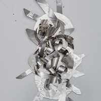 A Tale of Two-Abstract Art Piece Hung on A Wall With Various Shapes that Resembles Ties. The Ties are Bent in Various Ways. The Piece is Silver. 