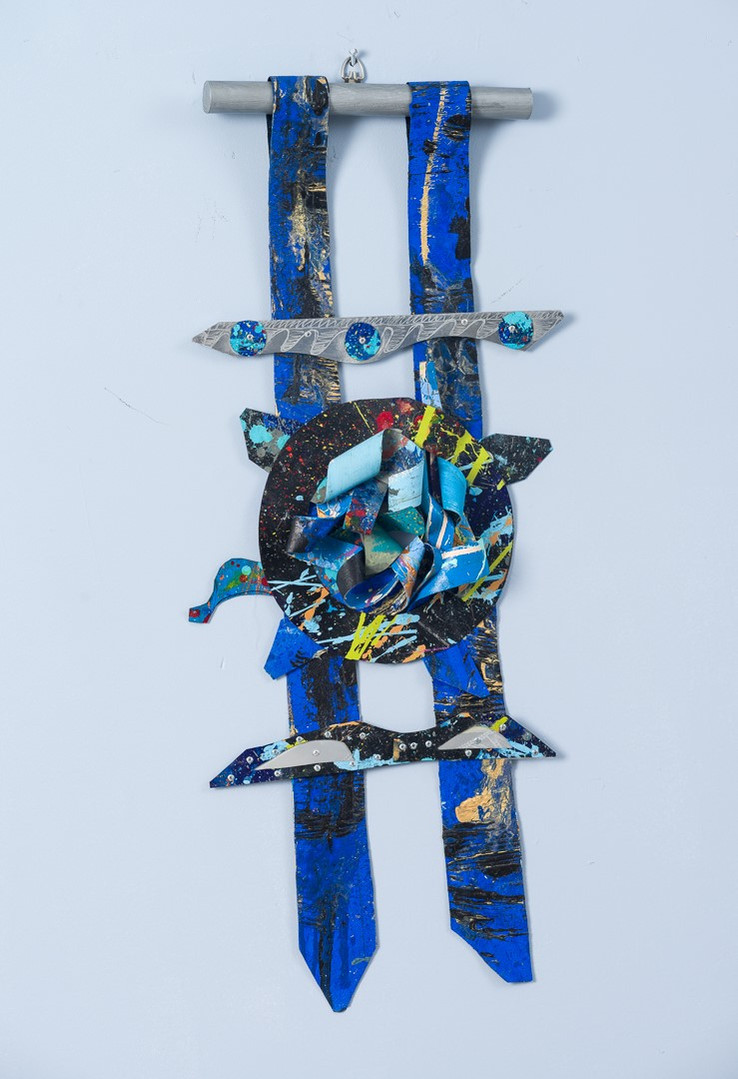 Silent Moment-Abstract cutout art piece on paper that resembles ladder  which has a circle in the middle. The colors of the piece are mostly blue with gray and hints of green.