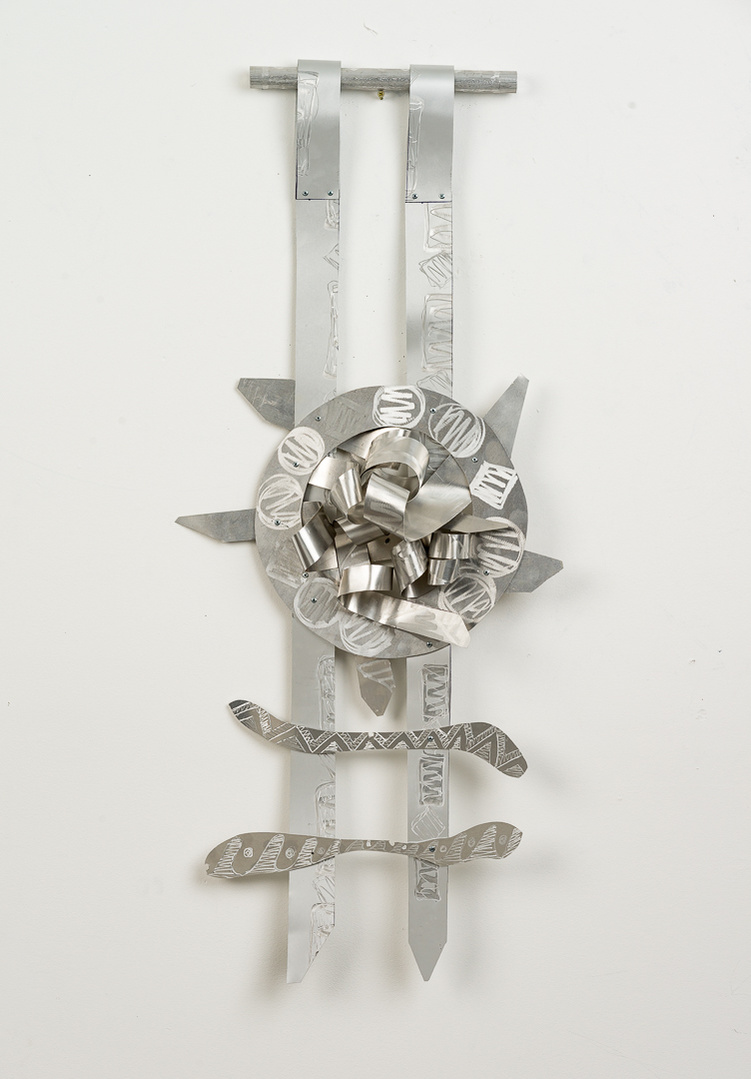 Target Ladder-Abstract Art Piece With Various Shapes that Resembles Ties. The Ties are Bent in Various Ways. The Piece is Silver.