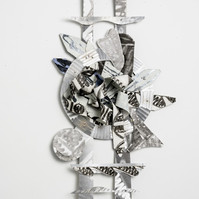 In Times Like These Ladder For Ahmaud-Abstract cutout art piece on paper that resembles a ladder with abstract shapes in the middle of the ladder.  The colors of this piece are silver with hints of black.