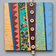 Which Way-Multicolored Abstract Art Painting With Various Patterns and Shapes. This Painting Has Wooden Pegs and Circles in the Middle, Top and Bottom.