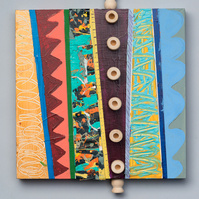 Which Way-Multicolored Abstract Art Painting With Various Patterns and Shapes. This Painting Has Wooden Pegs and Circles in the Middle, Top and Bottom.
