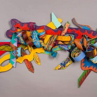 Unsung For Bob-Multicolored Abstract Art Piece Hung on A Wall With Various Shapes that Resembles Ties. The Ties are Bent in Various Ways. 